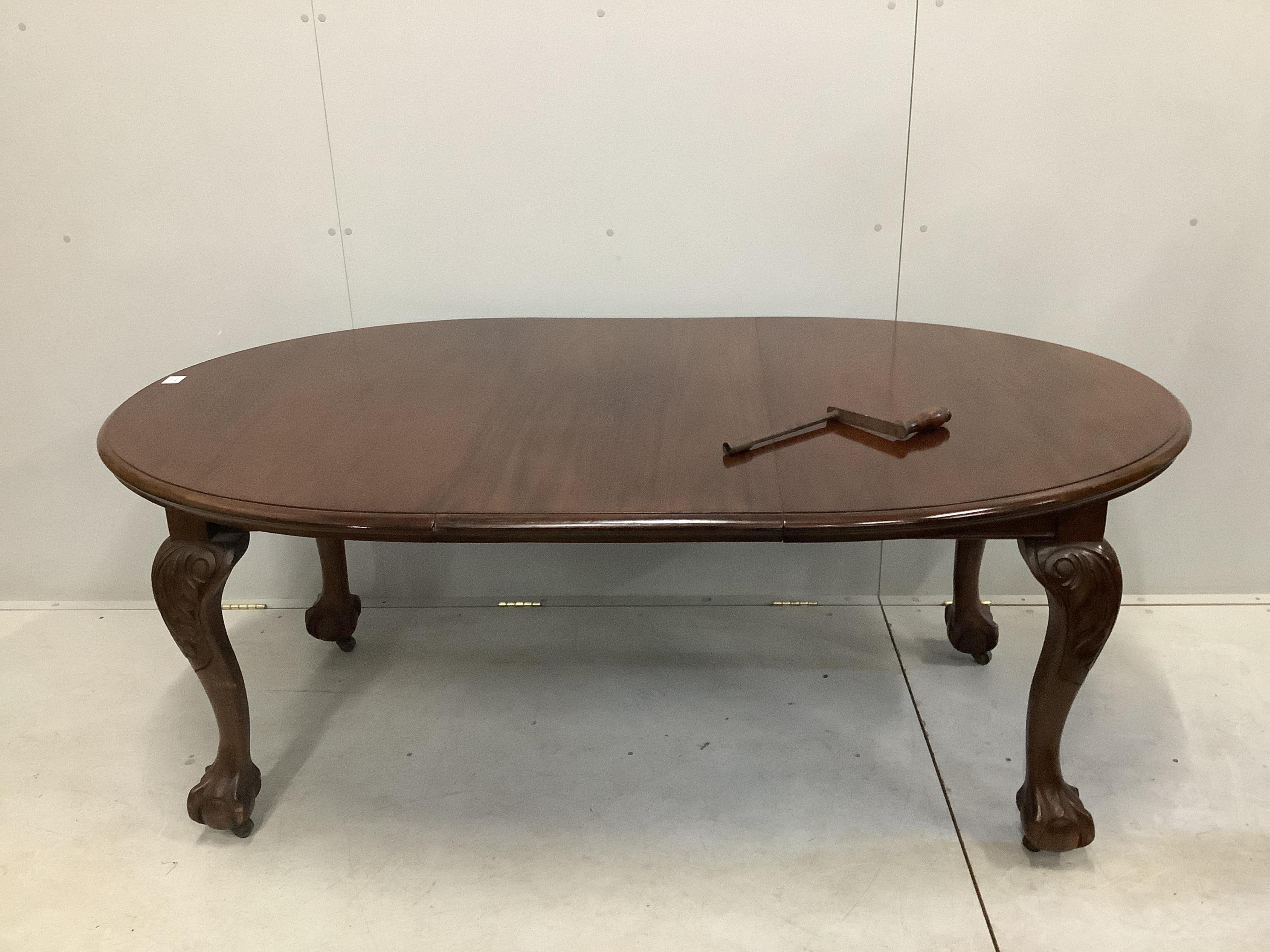 A 1930's walnut extending dining table, 182cm extended, height 106cm and a set of six Queen Anne Revival dining chairs. Condition - fair to good